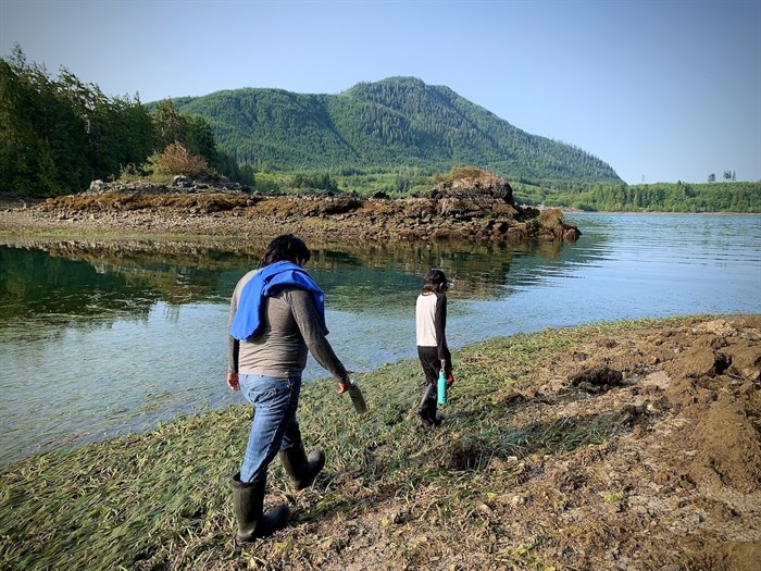 Chuck John and his son James hike the beach in Huu-ay-aht territory while taking part in the Nuu-chah-nulth Youth Warriors program in early July.