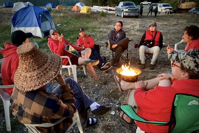 Youth Warriors and mentors chat around the propane campfire at day's end during a trip and community project in Huu-ay-aht territory in July.