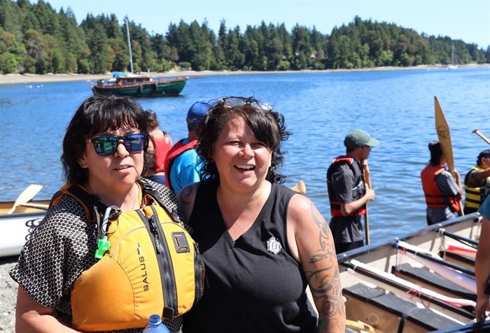 Michelle Robinson, a member of the Klahoose Nation’s Tl'emtl'ems canoe family, along with a paddler after being welcomed to Stz'uminus First Nation territory for the launch of their Tribal Journey to Muckleshoot.