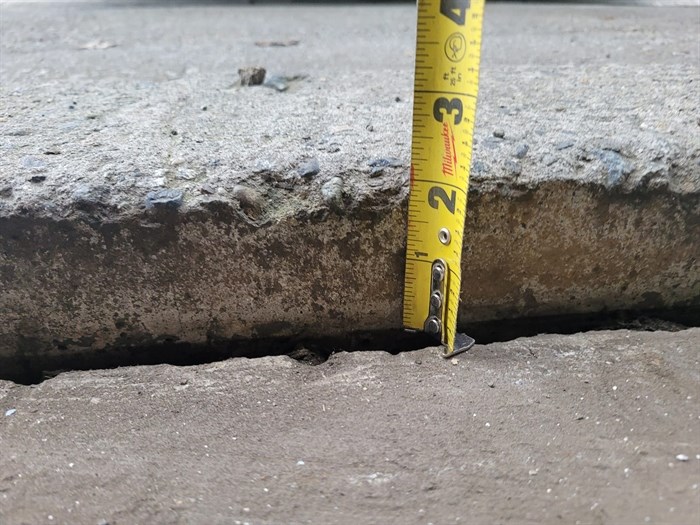 Okanagan Lift and Level showing uneven concrete with measuring tape