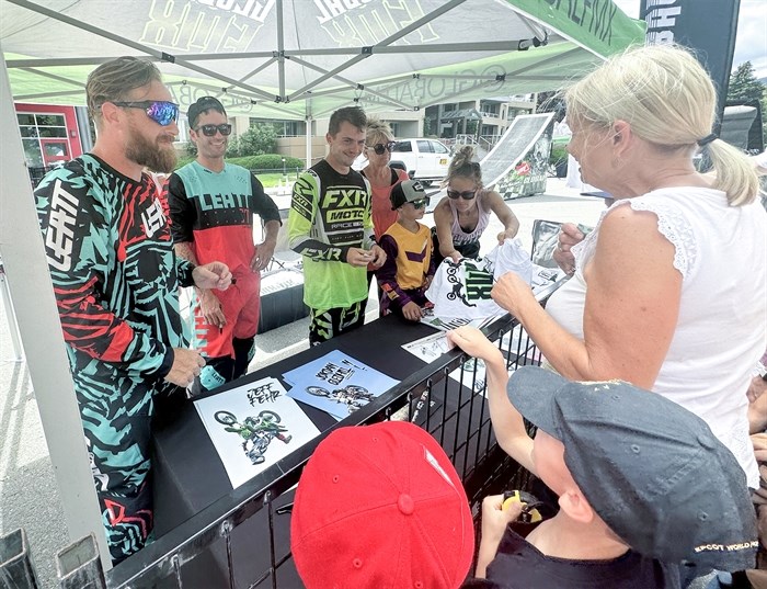 GlobalFMX riders, left to right, Jeff Fehr, Chris Nolan, Jordan Gledhill and nine-year-old Kruz Garwasiuk sign autographs for fans after the show.