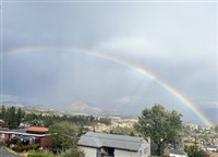 Almost an entire rainbow arc is seen over West Kelowna. 