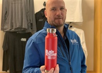 Gordon Blair, owner of Blair Sportswear and Apparel, holds a branded water bottle, one of many items the embroidery company can imprint.