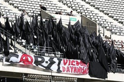 Supporters of Besiktas stand black flags to express their condolences for the victims of Soma mine accident before their Turkish League match in Istanbul, Turkey, Saturday, May 17, 2014.
