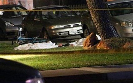 Bodies are seen covered on the ground after a mass shooting near the campus of the University of Santa Barbara in Isla Vista, Calif., Friday, May 23, 2014.