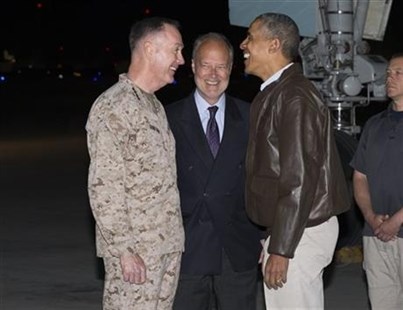 President Barack Obama, right, is greeted by US Ambassador to Afghanistan James Cunningham, center, and Marine General Joseph Dunford, commander of the US-led International Security Assistance Force (ISAF), after arriving at Bagram Air Field for an unannounced visit, on Sunday, May 25, 2014, north of Kabul, Afghanistan.