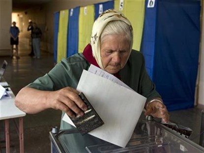 An elderly woman casts her vote in the presidential election in the eastern town of Krasnoarmeisk, Ukraine, Sunday, May 25, 2014.