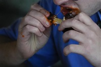 A man eats a chicken wing, Wednesday, June 12, 2024, at a barbecue restaurant in Cincinnati. Psychologists have known for years now that men tend to eat more meat than women, but a study of people around the world now reveals that that&#39;s true across cultures. 