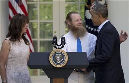 President Barack Obama shakes hands with Bob Bergdahl as Jani Bergdahl stands at left, in the Rose Garden of the White House on May 31, 2014.