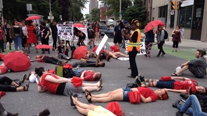 Demonstrators protest the Harper government's proposed prostitution legislation on a Toronto street Saturday, June 14, 2014.