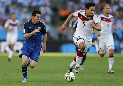 Argentina's Lionel Messi, left, and Germany's Mats Hummels go downfield during the World Cup final soccer match between Germany and Argentina at the Maracana Stadium in Rio de Janeiro, Brazil, Sunday, July 13, 2014.
