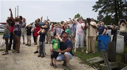 Spectators watch as the Orbital Sciences Corporation Antares rocket launches with the Cygnus spacecraft onboard from NASA's Wallops Flight Facility, Sunday, July 13, 2014, Atlantic, Va.