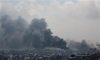 Smoke rises after an Israeli missile hit Shijaiyah neighborhood in Gaza City, northern Gaza Strip, Sunday, July 20, 2014.