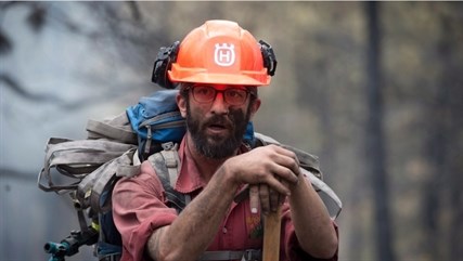 Fire fighter Jake Sparks pauses for a moment at the Smith Creek fire in West Kelowna, Saturday, July, 19, 2014.
