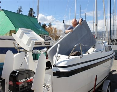 Jim Schisler gets his sail boat ready for a future launch at an Okanagan Lake marina today.