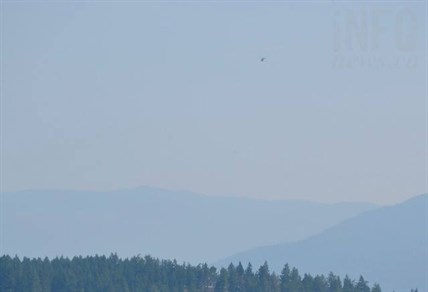 A B.C. Wildfire helicopter flies above Armstrong, B.C.
