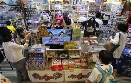 Shoppers gather around the items featuring Youkai Watch characters.