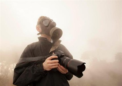 Kelowna photographer Shawn Talbot puts on a gas mask and jacket to protect himself from the blazing heat emitting from the lava.