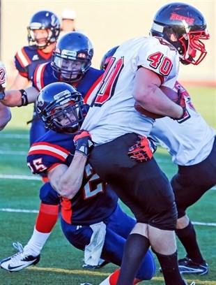 Mutrie makes a tackle for the Broncos in this 2014 photo. 