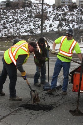 Public works employees along Mission Flats Road in Kamloops earlier this year.