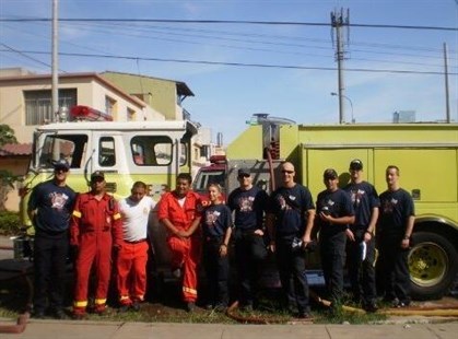 Paley (third from right) during training in Peru. The fire truck is from Merrit, B.C. and was re-painted red for the Bomberos - Peru's national fire service.