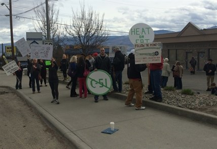 A small group of concerned citizens protested high power rates outside Premier Christy Clark's riding office in West Kelowna, Saturday, March 14, 2015.