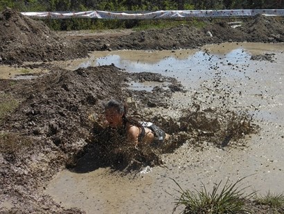 Participants were required to race each other through a stretch of deep muddy terrain two times. 