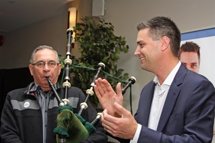 Conservative Peter Sharp plays the bagpipes for Liberal Todd Stone as he comes to congratulate him on his win.