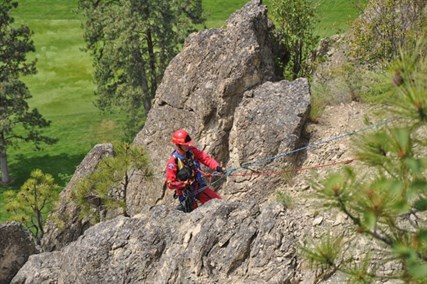 A firefighter had to repel down about 50 feet down a cliff to rescue the dog.