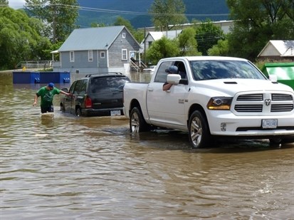 Flooding in the back parking lot of the Sheardowns grocery store in Lumby on June 21.  