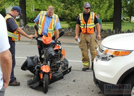 Emergency responders attend a collision between a moped and a white truck late Wednesday afternoon in front of Eckhardt Dental Centre on Martin Street. The truck's driver was instructed to drive her vehicle off the moped. There was no sign of the moped's rider.