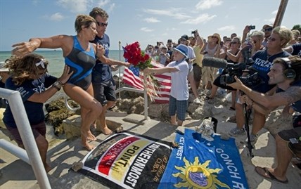 Endurance swimmer Diana Nyad is helped to shore and welcomed by her team after swimming a short distance from a support boat August 21, 2012 in Key West, Florida. Nyad failed in a fourth attempt to complete a swim across the Florida Straits from Cuba to the Florida Keys.