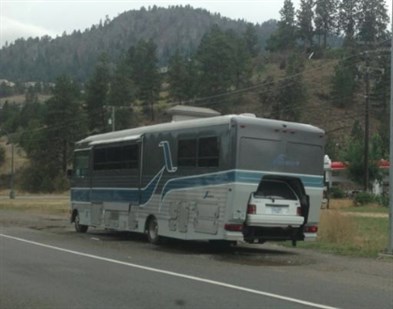 The mother bus couldn't make it to the garage in time and gave birth to a white sub-compact on the side of the road in Peachland. Mother and baby are doing just fine.