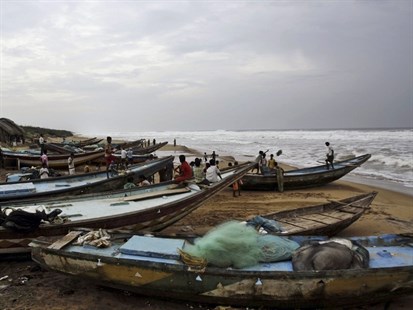 Indian villagers look at the Bay of Bengal in Gokhurkuda, Friday, Oct. 11, 2013.