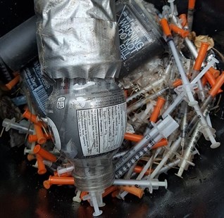 Used needles were found at a backcountry garbage dump.