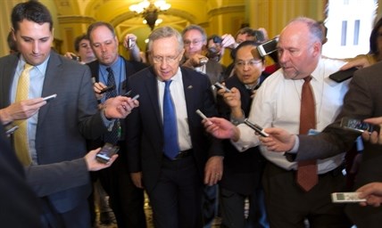 Senate Majority Leader Sen. Harry Reid, D-Nev., is surrounded by reporters.