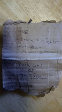 The note found tucked in the door of the cabin.