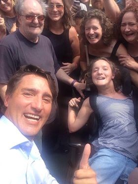 Katie Ostrander (bottom), Jackie Ostrander (top right), Amie Harbor (centre) and Thomas Sutter (left) get a selfie with Prime Minister Justin Trudeau.