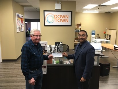Victor Lepp, left, receives a cheque from DVA board member Umang Patel for the Dental Access Centre.