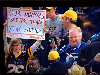 A Hamilton Tiger Cats fan openly mocks Toronto mayor Rob Ford with her sign at the CFL eastern semifinal in Toronto on Sunday, Nov. 17, 2013.