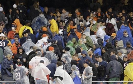 Fans begin to leave their seats as a severe storm blows through Soldier Field in Chicago during an NFL football game between the Chicago Bears and the Baltimore Ravens. Play was suspended in the game.