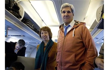 U.S. Secretary of State John Kerry, right, and EU foreign policy chief Catherine Ashton, left, visit the media seating area of Kerry's aircraft as it sits on the tarmac at Geneva International airport before leaving for London, Sunday, Nov. 24, 2013, in Geneva, Switzerland. A deal has been reached between six world powers and Iran that calls on Tehran to limit its nuclear activities in return for sanctions relief, the French and Iranian foreign ministers said early Sunday.