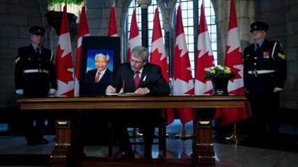 Canadian Prime Minister Stephen Harper signs a Book of Condolence after the passing of Nelson Mandela Friday December 6, 2013 on Parliament Hill in Ottawa. 