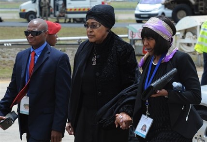 Winnie Madikizela-Mandela, Nelson Mandela's former wife, arrives with Ndileka Mandela, right, at Mthatha Airport in Mthatha, South Africa, Saturday, Dec. 14, 2013.