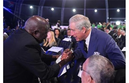 Britain's Prince Charles, right, is greeted by another mourner as he arrives for the funeral service for former South African president Nelson Mandela in Qunu, South Africa, Sunday, December 15, 2013.