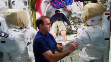 Expedition 38 crew member Rick Mastracchio, left, checks out the spacesuit that he will wear during a spacewalk with crew member Mike Hopkins, in the Quest airlock in the International Space Station in this undated image taken from video from NASA TV. Mastracchio and fellow astronaut Mike Hopkins will conduct a series of spacewalks beginning Saturday, Dec. 21, 2013 to replace an ammonia pump that is part of the station's coolant system. This will be Hopkins' first spacewalk, while Mastracchio has had six previous ones.