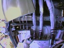 Spacewalker Rick Mastracchio works to disconnect the fluid lines from the degraded pump module in this view from the NASA astronaut's helmet camera on Saturday, Dec. 21, 2013.