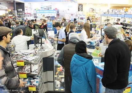 A thick crowd gathers around this employee cash register fortress at London Drugs at the Cherry Lane Mall today.