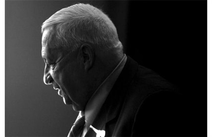 In this 2005 file photo, Israeli Prime Minister Ariel Sharon smiles during a question and answer session with Israeli news editors at the Journalist’s Association in Tel Aviv.
