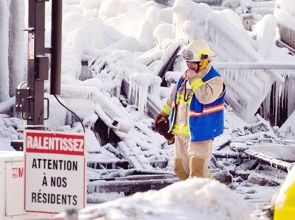 An emergency worker walks past a sign that reads 